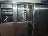 stainless steel refrigerators with racks of food inside of them in a kitchen