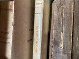 many old books stacked on a shelf in a room