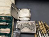 silverware and silverware in a case on a table