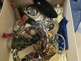 a box full of assorted jewelry on a table