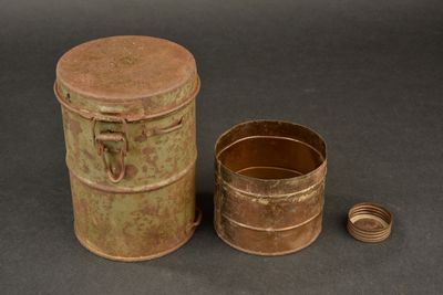 an old tin can and a small tin can on a table