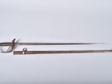a pair of swords, one of which has been used as a weapon, are shown on a white surface