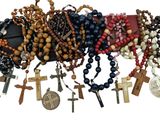 many different types of rosary hanging on the wall