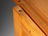 a close up of a bench made of wood with a piece of wood sticking out of it