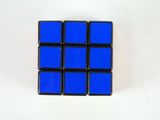 a blue cube sitting on top of a white table
