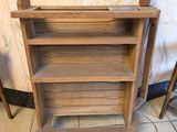 a wooden shelf that has a bunch of shelves on top of it