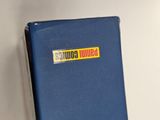 a close up of a blue book with a sticker on it