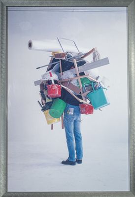 une photo d'un homme portant beaucoup de choses sur le dos