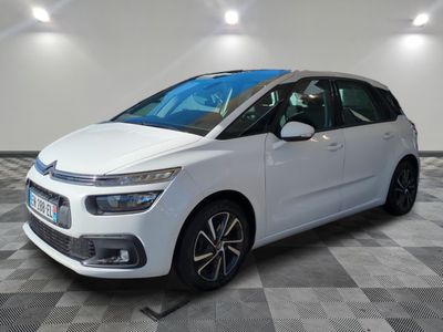 a white citrole is parked in a room with a checkered floor