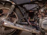 a close up of a motorcycle parked on the side of the street