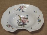 a plate with a flower design on it on a table