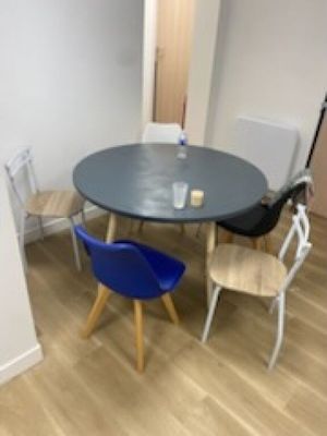 a table and chairs in a room with wood flooring