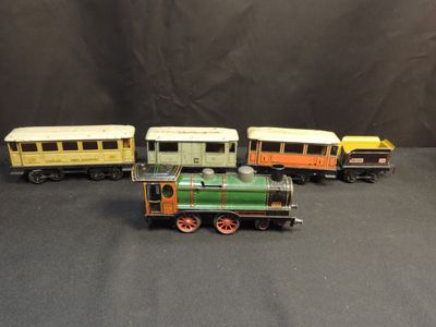 four toy trains that are lined up on a black surface