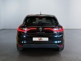 the rear end of a black car in a room with a white wall