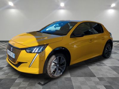 a yellow car is parked in a room with a checkered floor