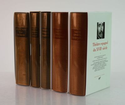 three books sitting on top of a white table next to each other