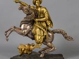 bronze statue of a man on a horse with a bird in his hand