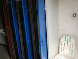 a white chair sitting in front of a row of blue lockers