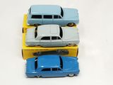 three toy cars sitting on top of each other on a table