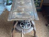 a small table with a wooden top on a carpeted floor