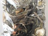 a bag full of assorted silver and gold jewelry