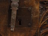 an old wooden chest with a lock and a key on it