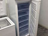 a white refrigerator and a freezer in a room