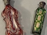two glass bottles that are sitting next to each other