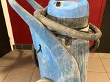 a blue and black cleaning machine on a tiled floor