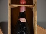 a bottle of wine in a wooden box on a table
