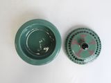 a small green object on the table next to a smaller green object