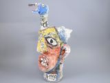 a ceramic sculpture of a man with a bird on his head