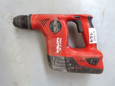 a red drill that is laying on a table
