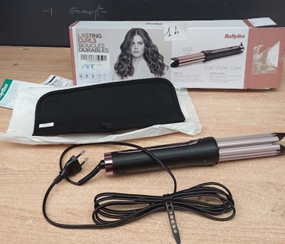 a box of hair straightens and a hair dryer on a table