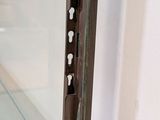 a close up of a door handle on a glass door