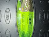 a close up of a cell phone with a green button on it
