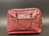 a pink leather handbag sitting on top of a table