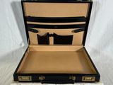 a black and white suitcase that is open on a white background