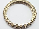 a close up of a gold ring on a white surface