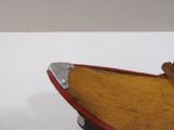 a wooden boat that is sitting on top of a table