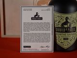a bottle of wine sitting next to a card on a table