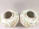 two vases that are sitting side by side on a table