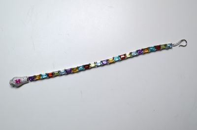 a close up of a beaded bracelet on a white surface