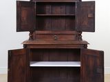 an old wooden cabinet with open doors and shelves in a room