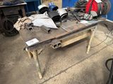 a table with a lot of tools on it in a garage