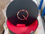 a black hat with a red circle on top of it