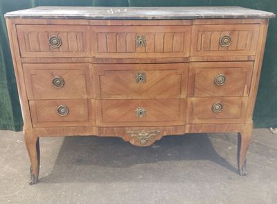 a dresser with a marble top in a room