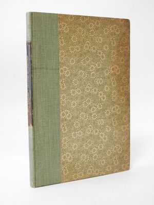 a book with a green cover sitting on top of a white surface