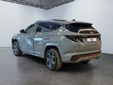 the rear end of a silver suv parked in a garage