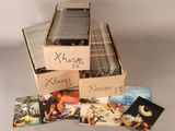a lot of cds in a cardboard box on a table